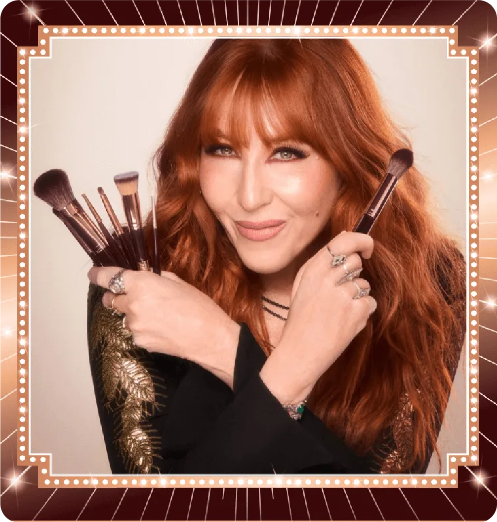 Professional portrait of makeup artist Charlotte Tilbury holding a set of luxury makeup brushes, demonstrating brand authority and expertise